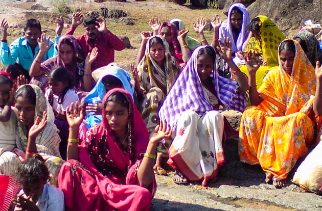 Southeast asian christians raise hands and pray together