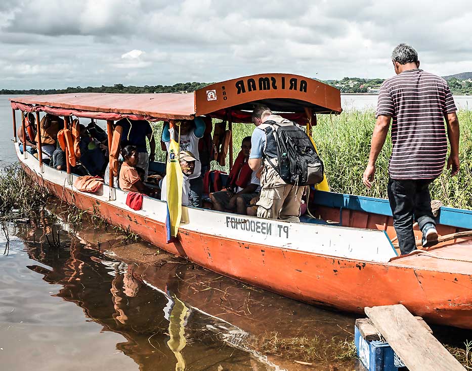 Venezuelans boarding a boat on a river