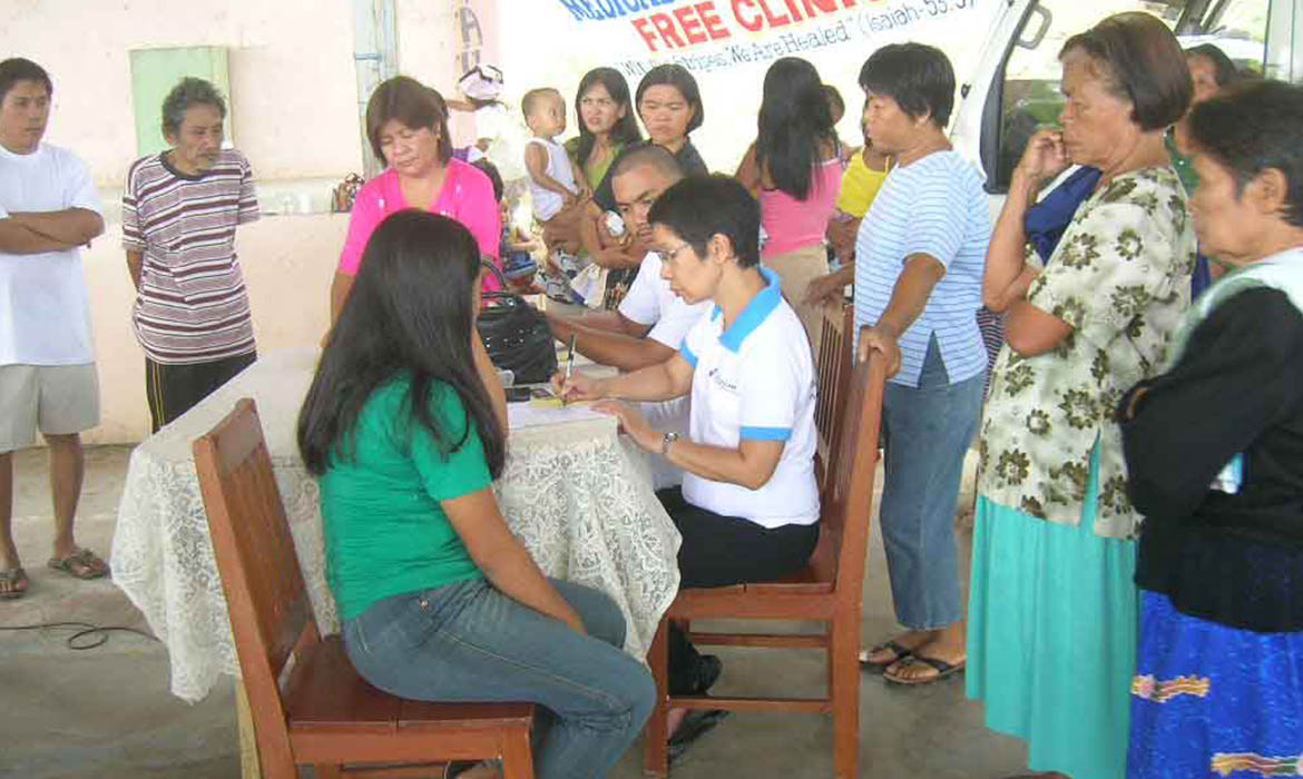 Men and women from Myanmar line up to register for a free healthcare clinic