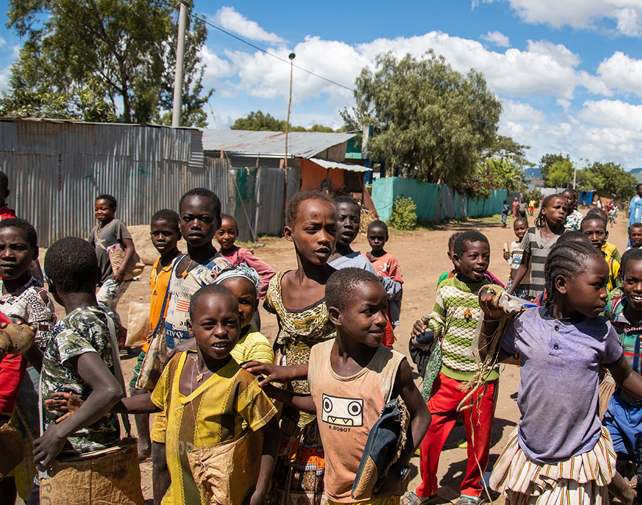 A group of Ethiopian kids standing in the street.