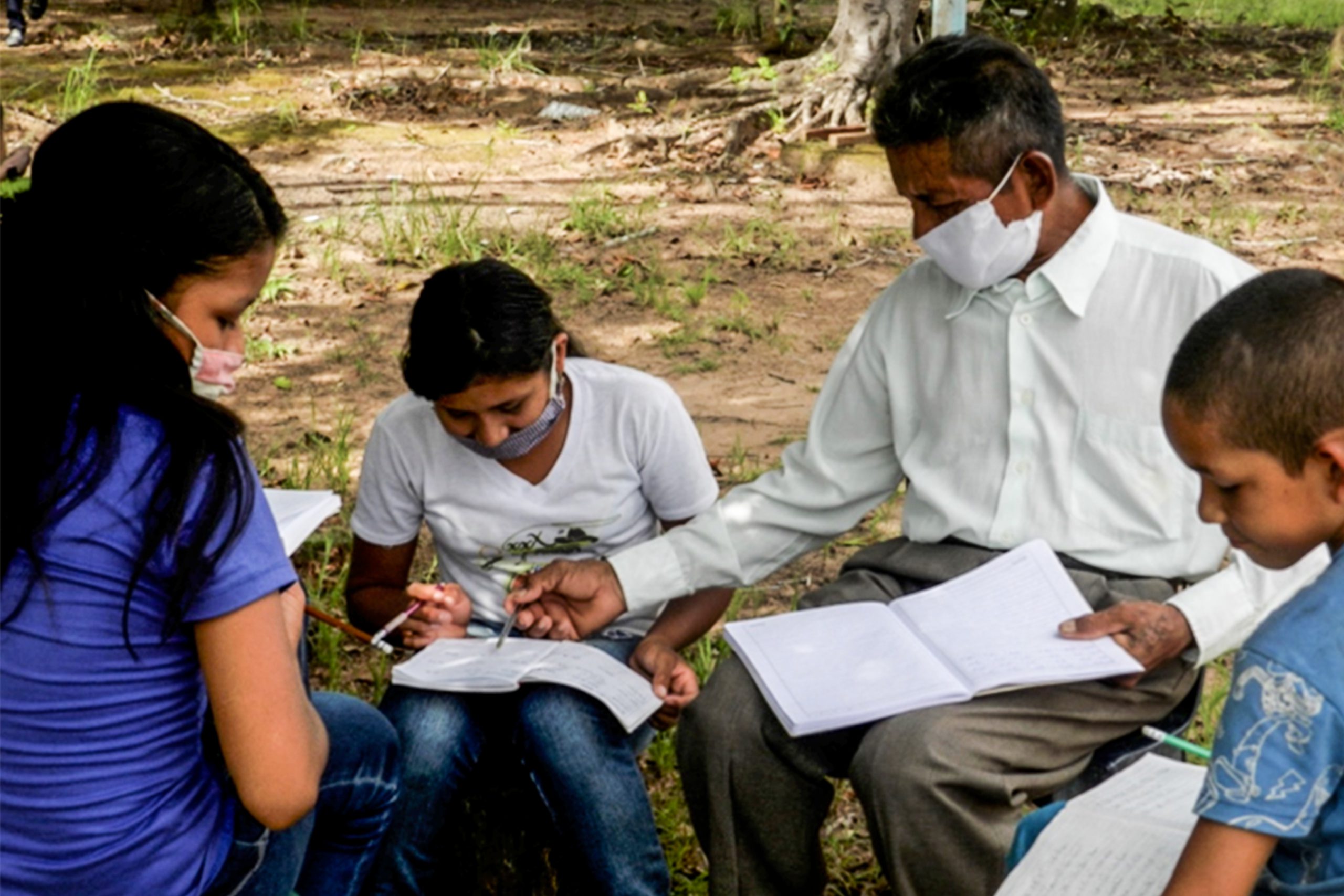 Venezuelan Christian teacher instructing his while outside