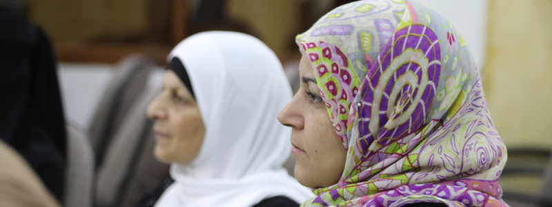 Two Syrian women with head coverings on