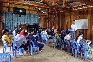 Vietnamese Christian missionary teaches children and teens in church