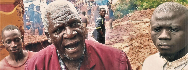 Liberian men working to dig a ditch in thick mud