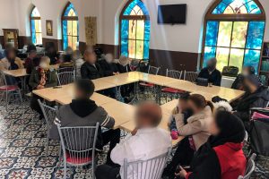 Turkish Christians sit at tables listening to the sunday sermon