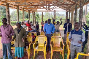 Christians in Kenyan stand singing praises to God in their church pavilion