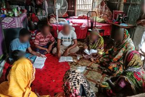 Bangladeshi Christians sit in a circle on the floor studying the Bible together