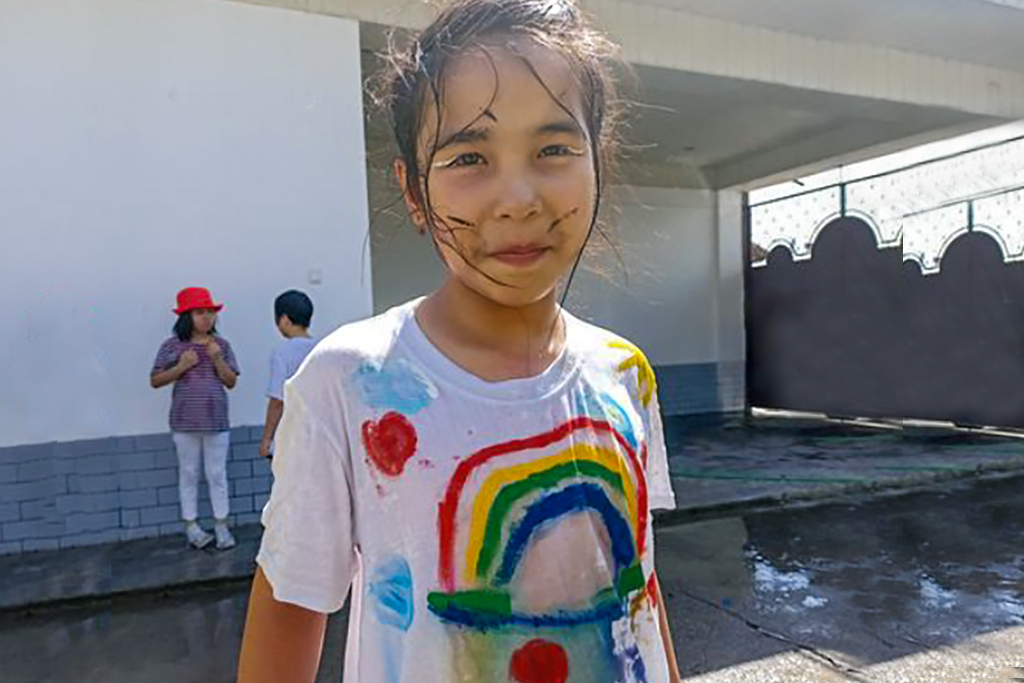 Kyrgyz girl with a white shirt that is painted