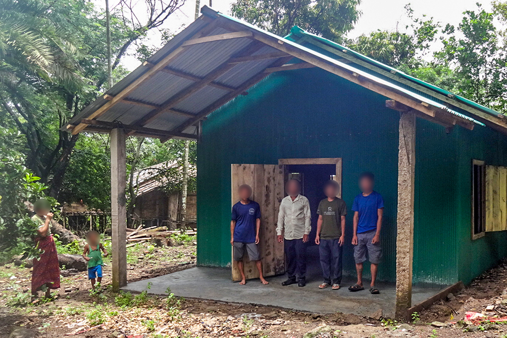 4 Christian men stand in front of their church in Bangladesh