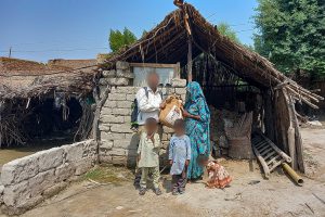 Pakistani family in front of their house