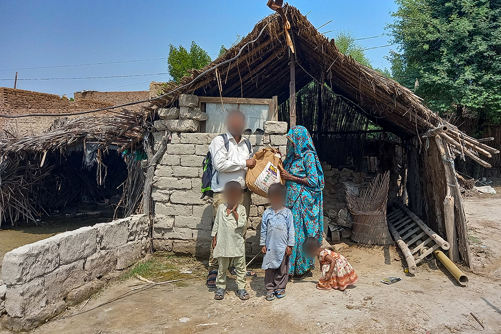 Pakistani family in front of their house