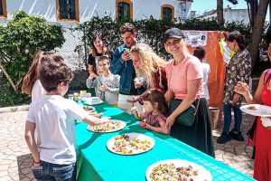 People gathering for a banquet outside in a town in Spain