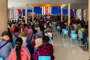 Chinese Christians gather for church with the choir singing in the front and the rest of the congregation sitting and listening