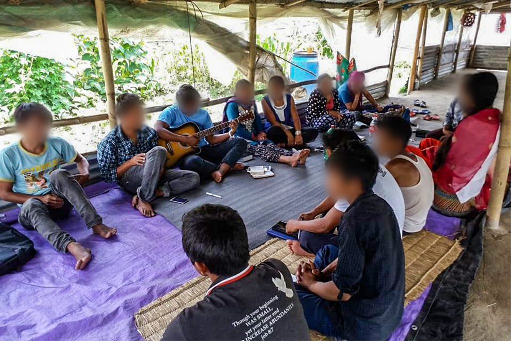 Nepalese Christians gather under pavilion and worship together