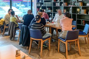 Refugees in Greece meet with Christian missionaries in a local restaurant