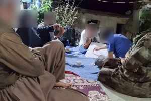 Iranian Christians gather together in a small group a while one of them teaches from a whiteboard