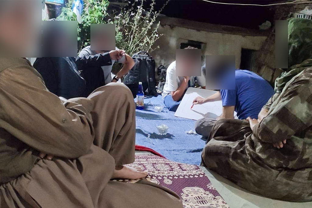 Iranian Christians gather together in a small group a while one of them teaches from a whiteboard