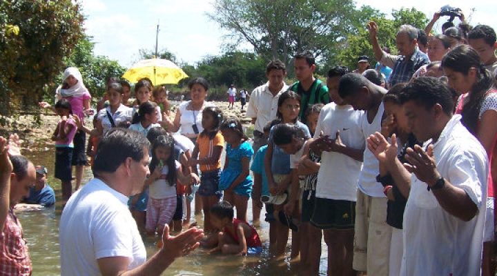 Colombian Christian missionary baptizes new Christians in a river